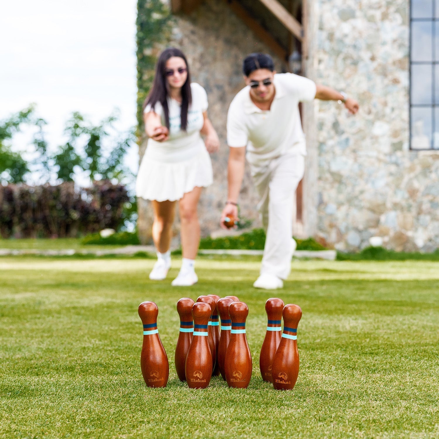 People playing Lawn Bowling in a park with the Elakai hardwood Lawn Bowling Set
