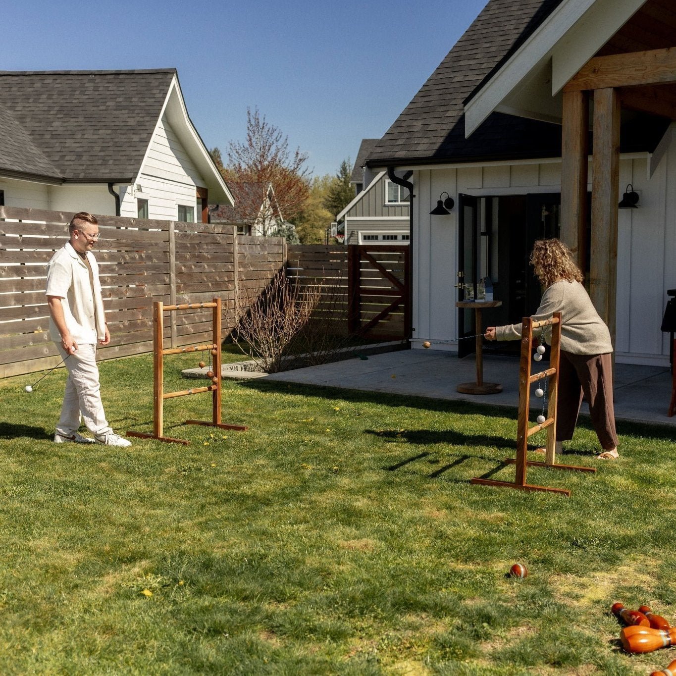 Players enjoying the Studio Series Mountain Ladder Ball Game Series Mountain Ladder Ball Game set up for backyard play Premium wooden Mountain Ladder Ball Game with solid acacia wood targets People playing the Studio Series Mountain Ladder Ball Game
