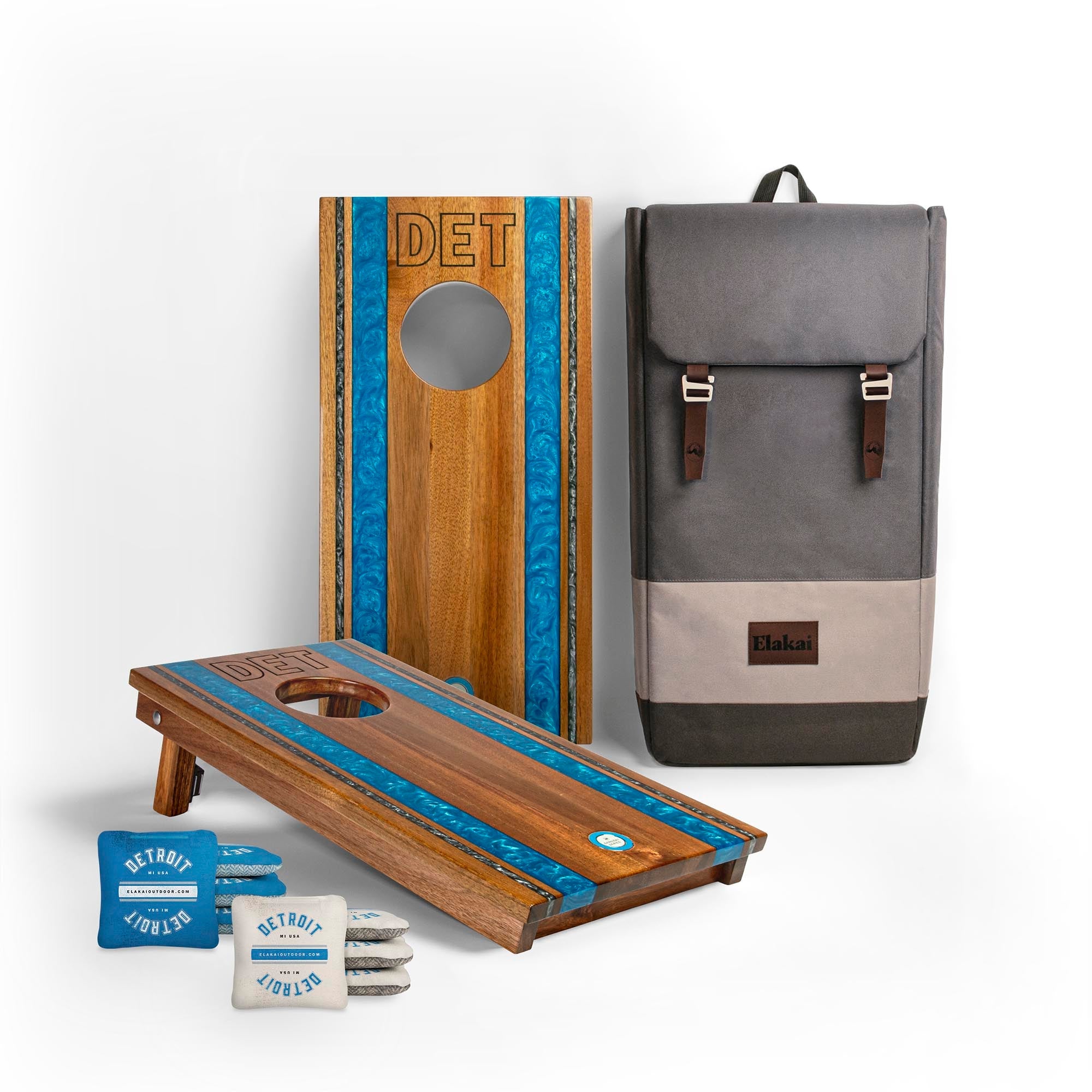 1x2 Gameday Resin Travel Cornhole Board Set with resin blue and gray-blue stripes, a gray backpack and two sets of Detroit cornhole bags
#color_detroit