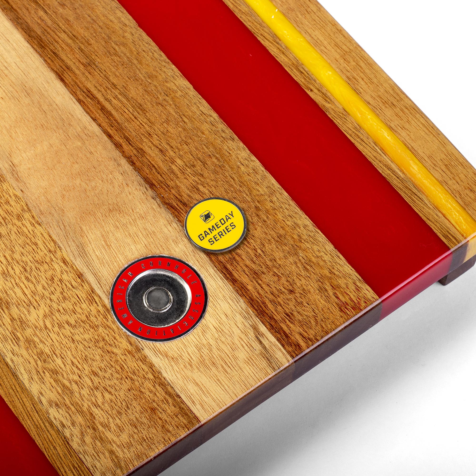 close-up detail of resin inlay and gameday coin insert on travel cornhole board
#color_kansas city