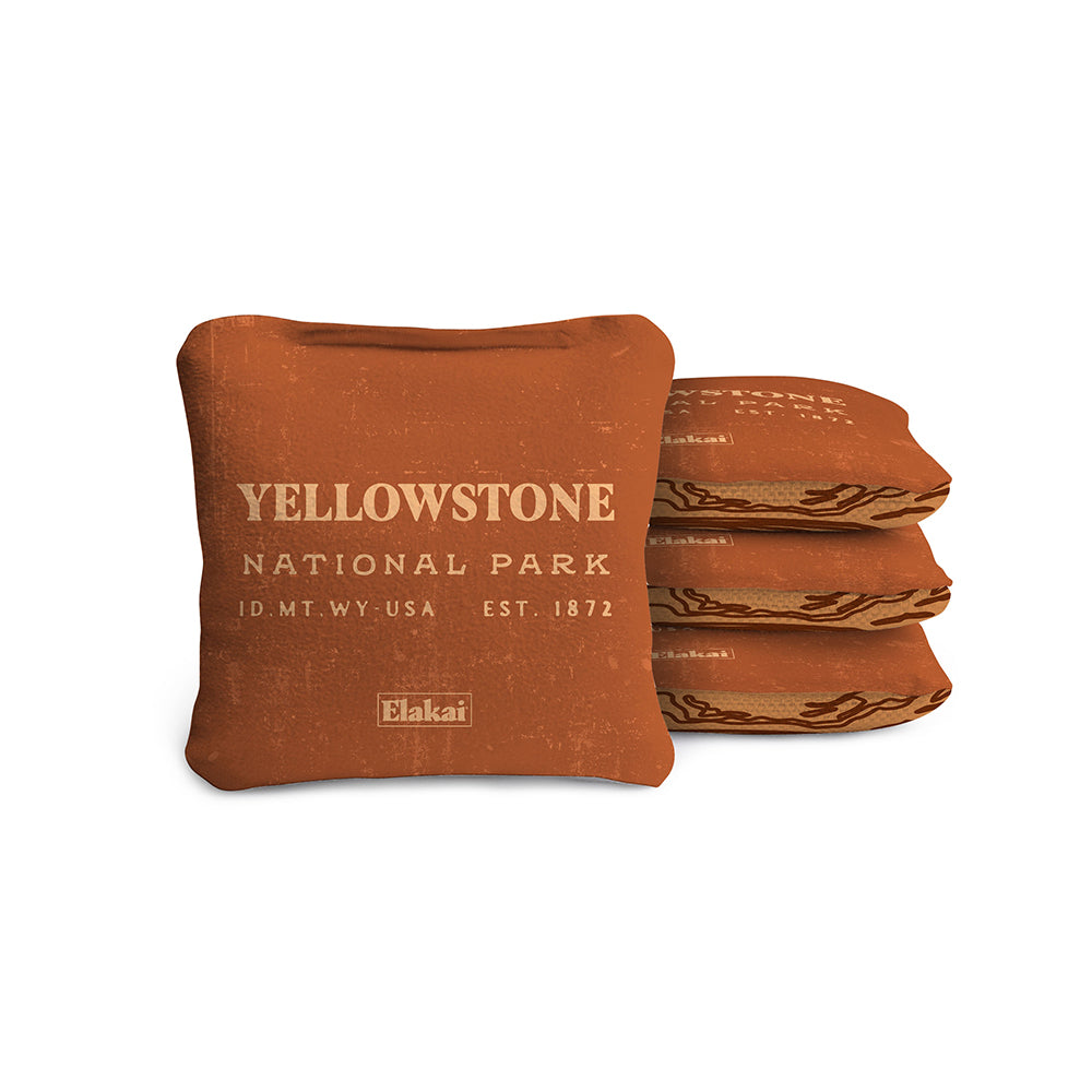 #color_burnt orange A set of four travel-size, all-weather cornhole bags with a Yellowstone National Park inspired design in brown color.
