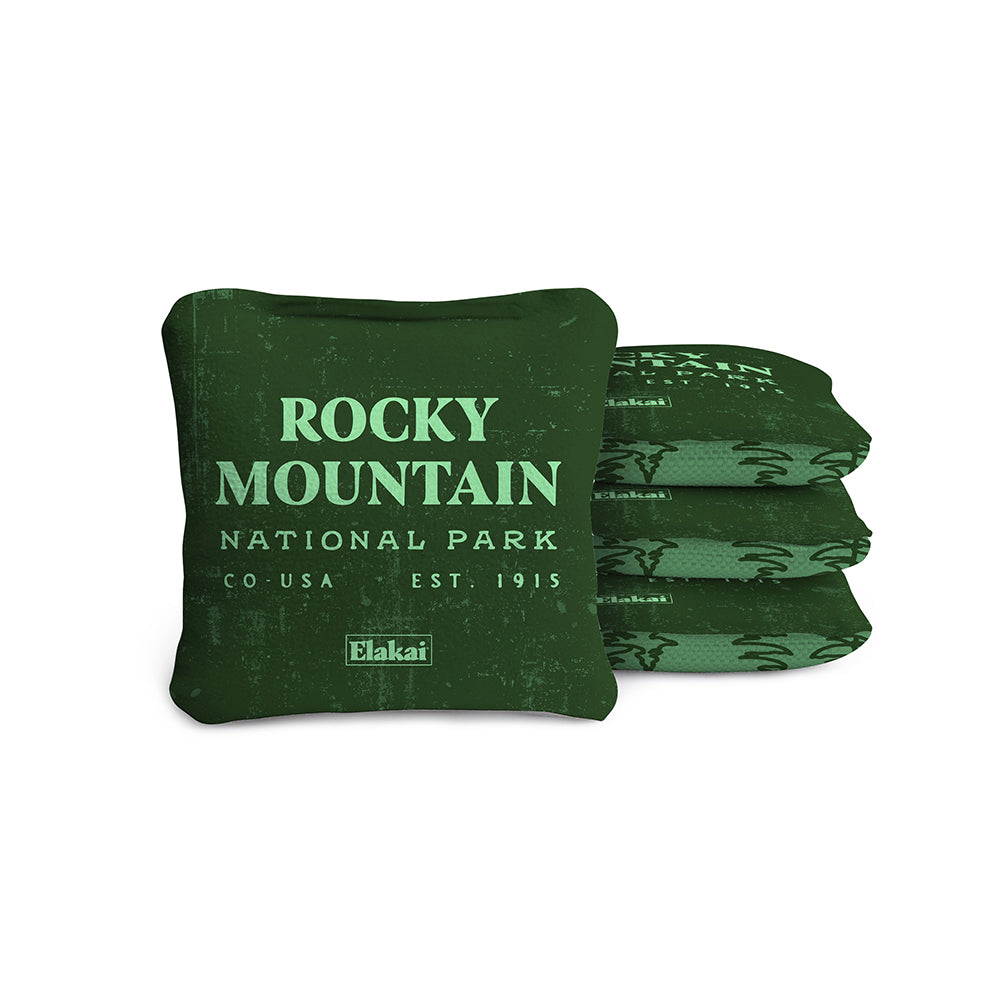 #color_green A set of four travel-size, all-weather cornhole bags with a dual-sided design featuring a green color and 'ROCKY MOUNTAIN NATIONAL PARK' text.