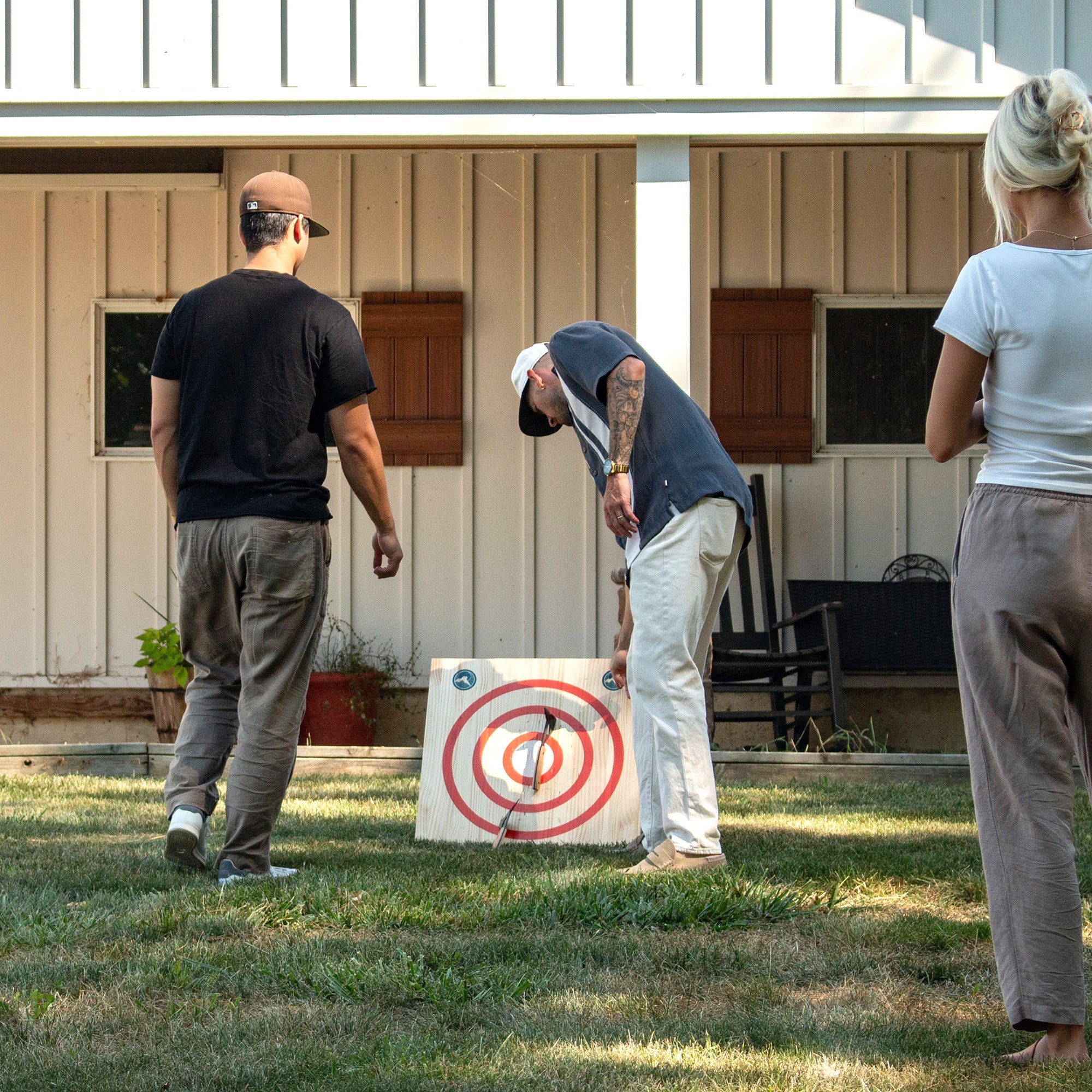 mini axe throwing target with three people hanging out