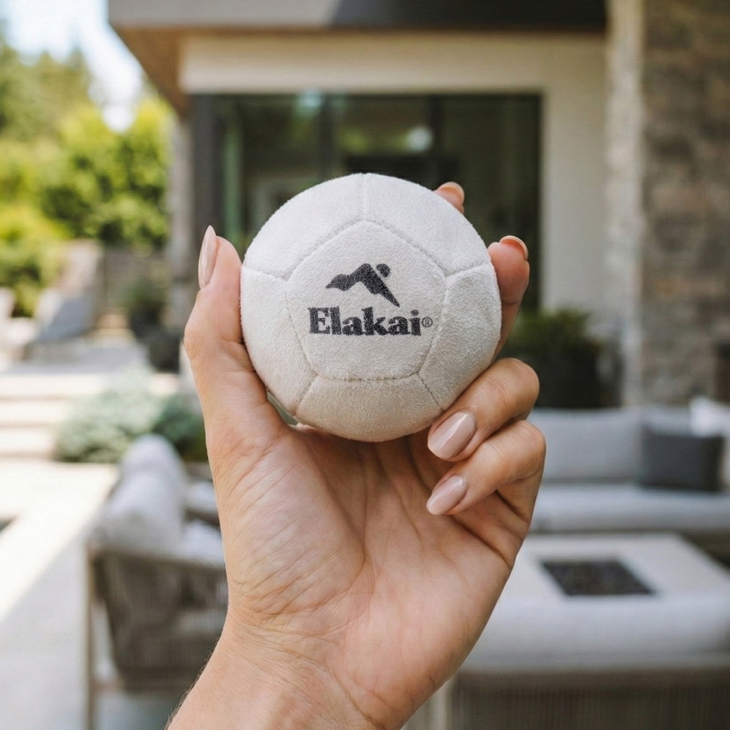 Elakai Soft Bocce ball held in hand to show size and scale for indoor play