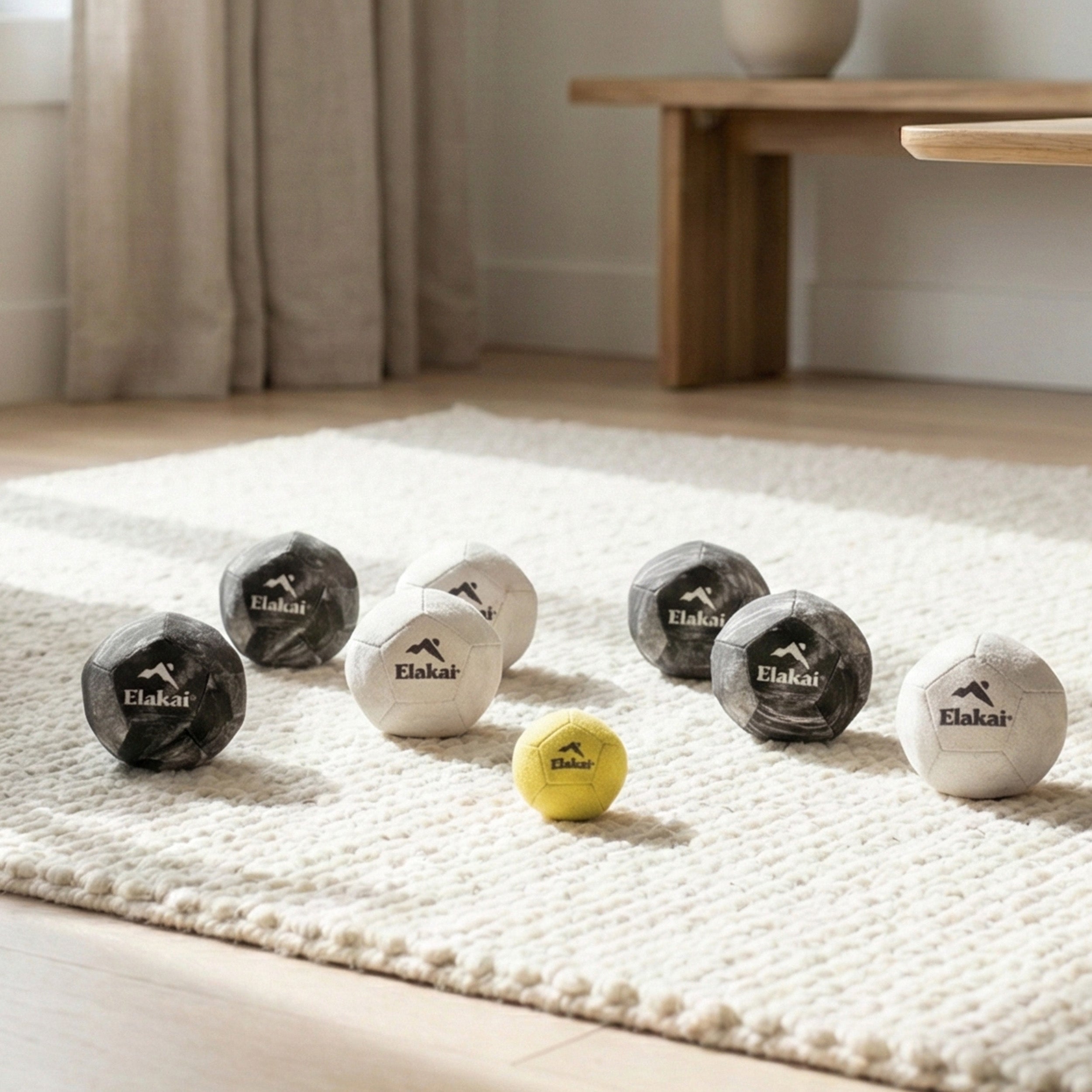 Elakai Soft Bocce balls arranged on a textured rug in a modern living room for relaxed indoor play