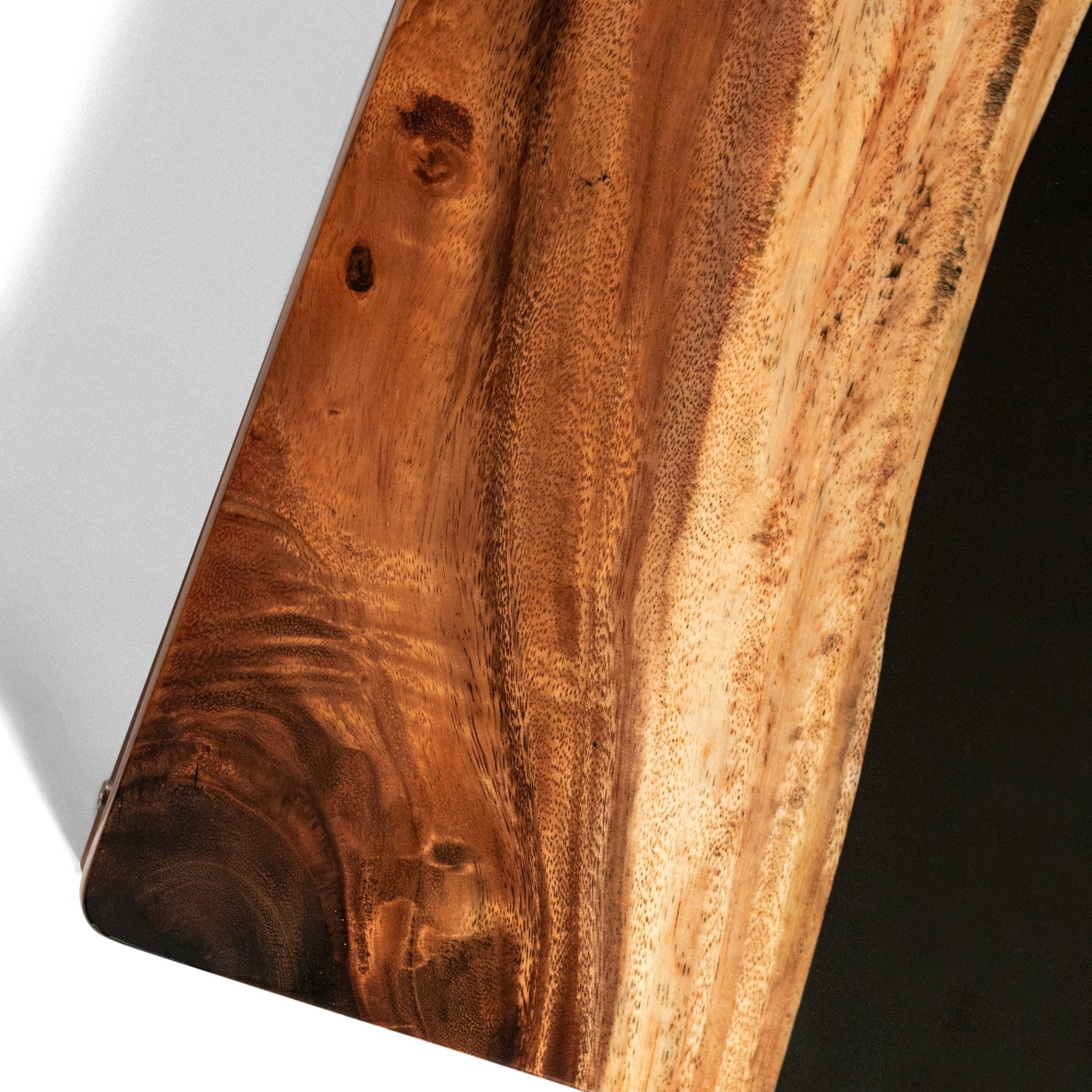 Close-up of a wooden cornhole board surface with a dark brown finish. #color_black