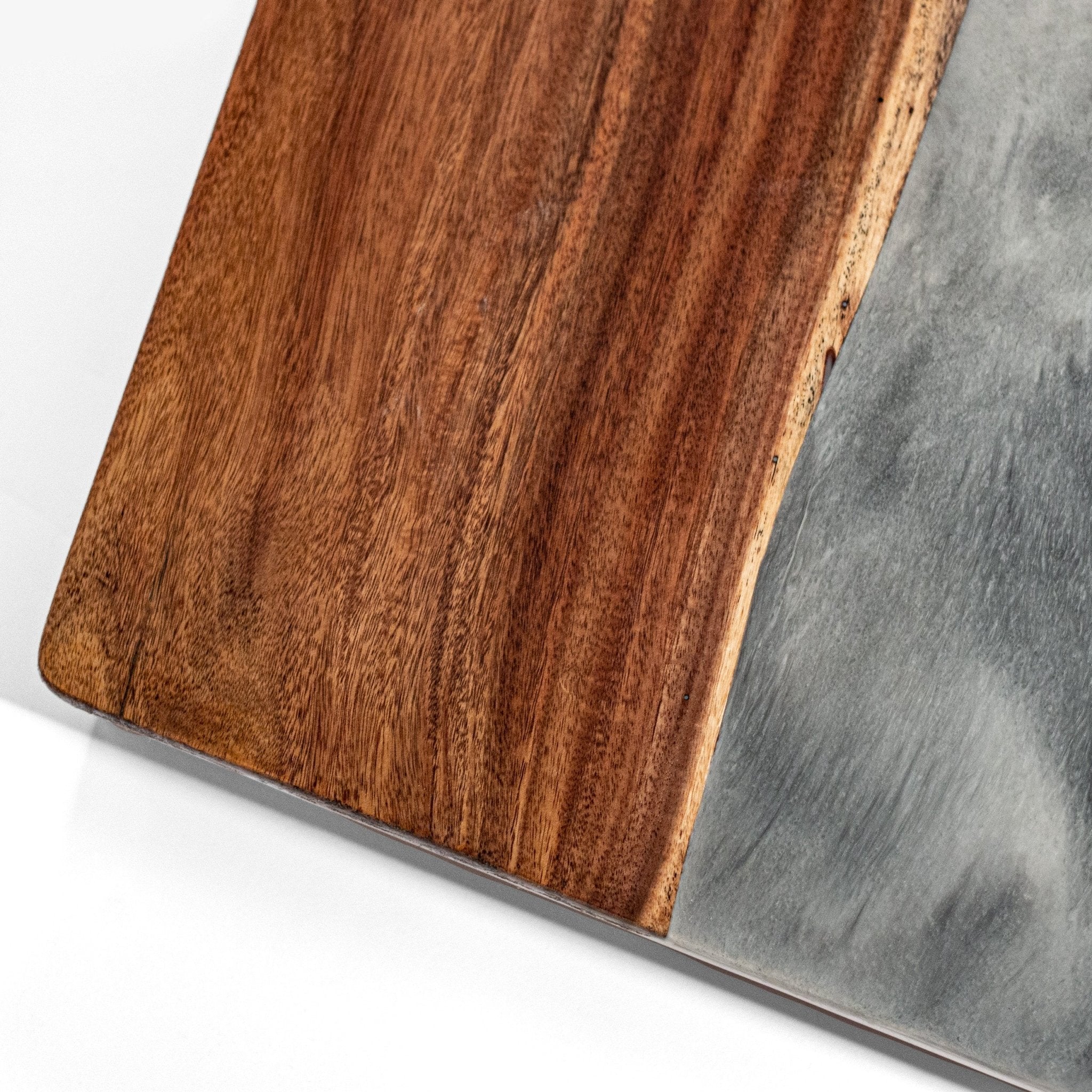 Close-up of a wooden cornhole board with a gray stone surface #color_gray stone