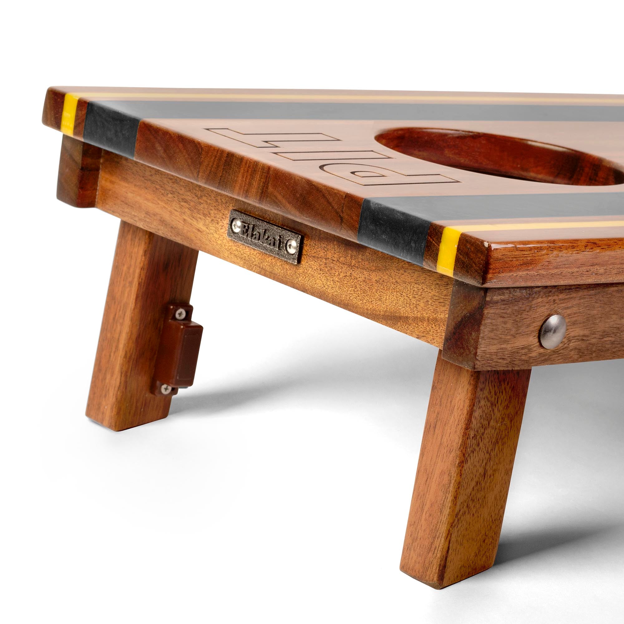 close-up detail of travel board with resin inlay, team engraving, folding legs, and metal Elakai badge 
#color_pittsburgh