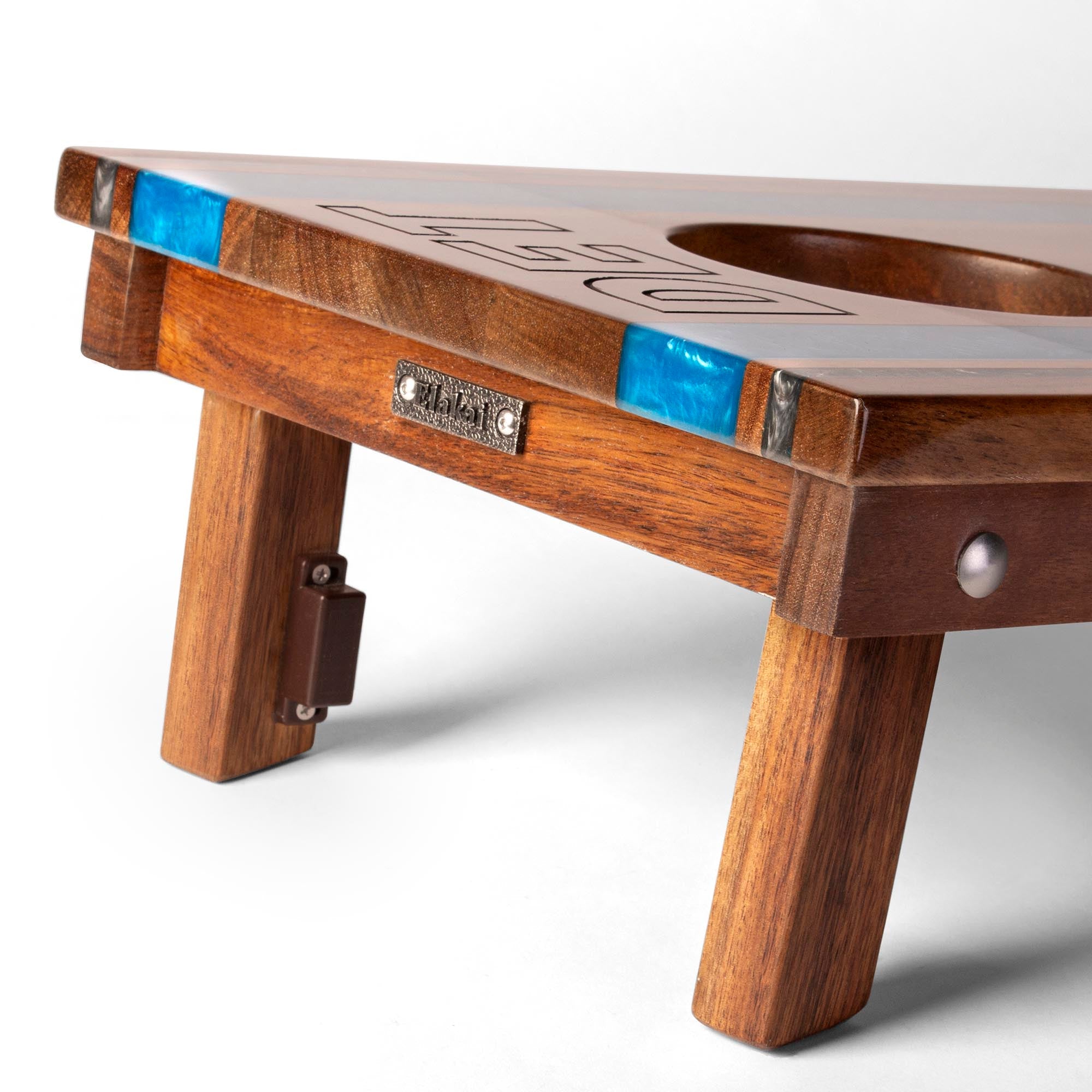 close-up detail of travel board with resin inlay, team engraving, folding legs, and metal Elakai badge 
#color_detroit