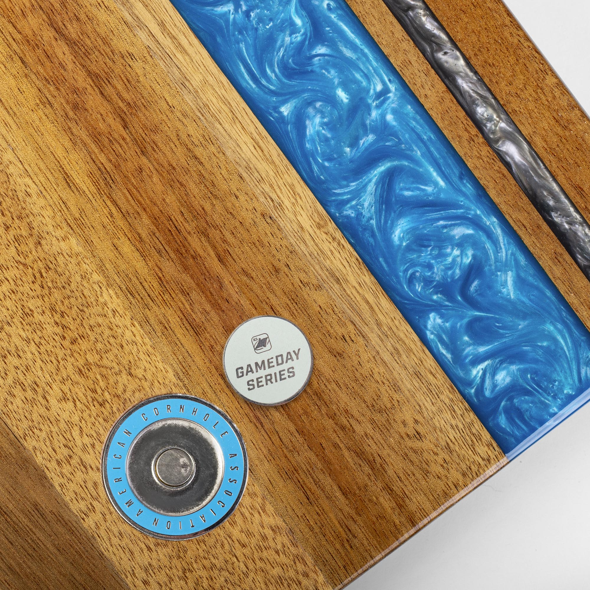 close-up detail of resin inlay and gameday coin insert on travel cornhole board
#color_detroit