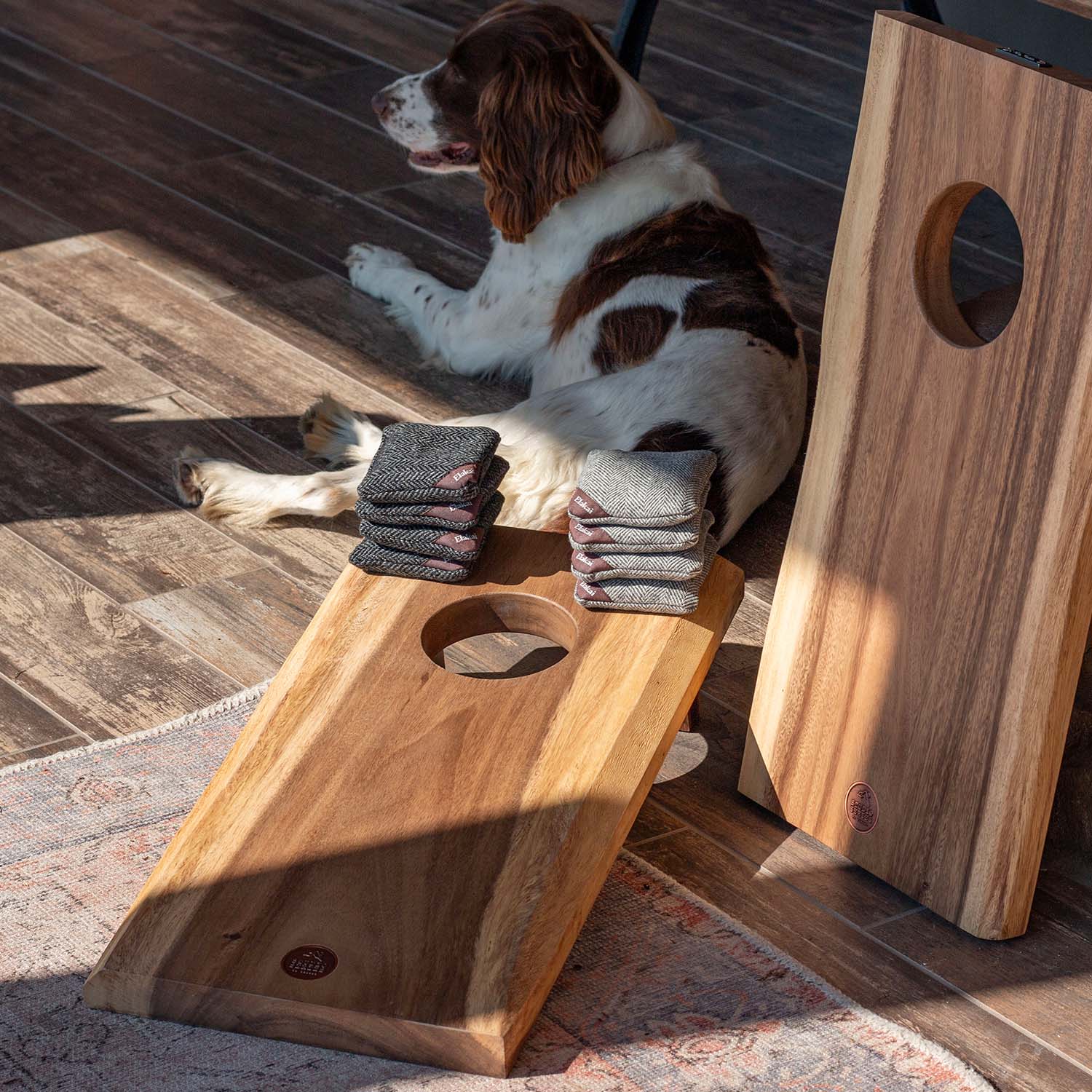 Portable Studio Series 1x2 cornhole boards in acacia wood with live edge and included accessories