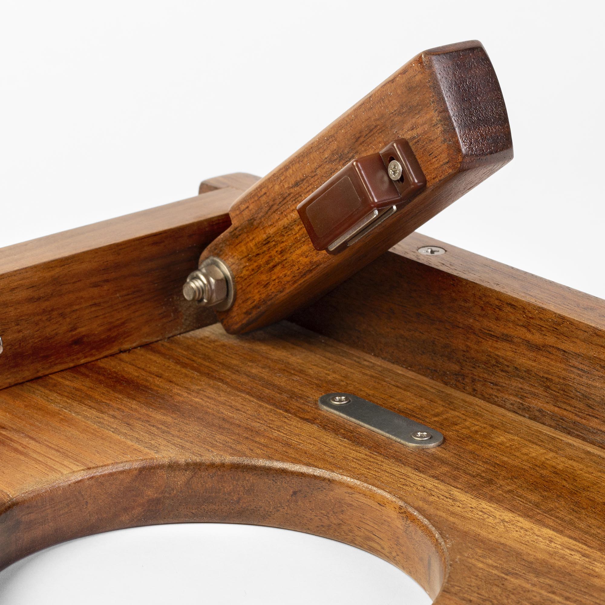 Close-up of magnetic collapsible legs with metal components on a 1x2 travel cornhole board