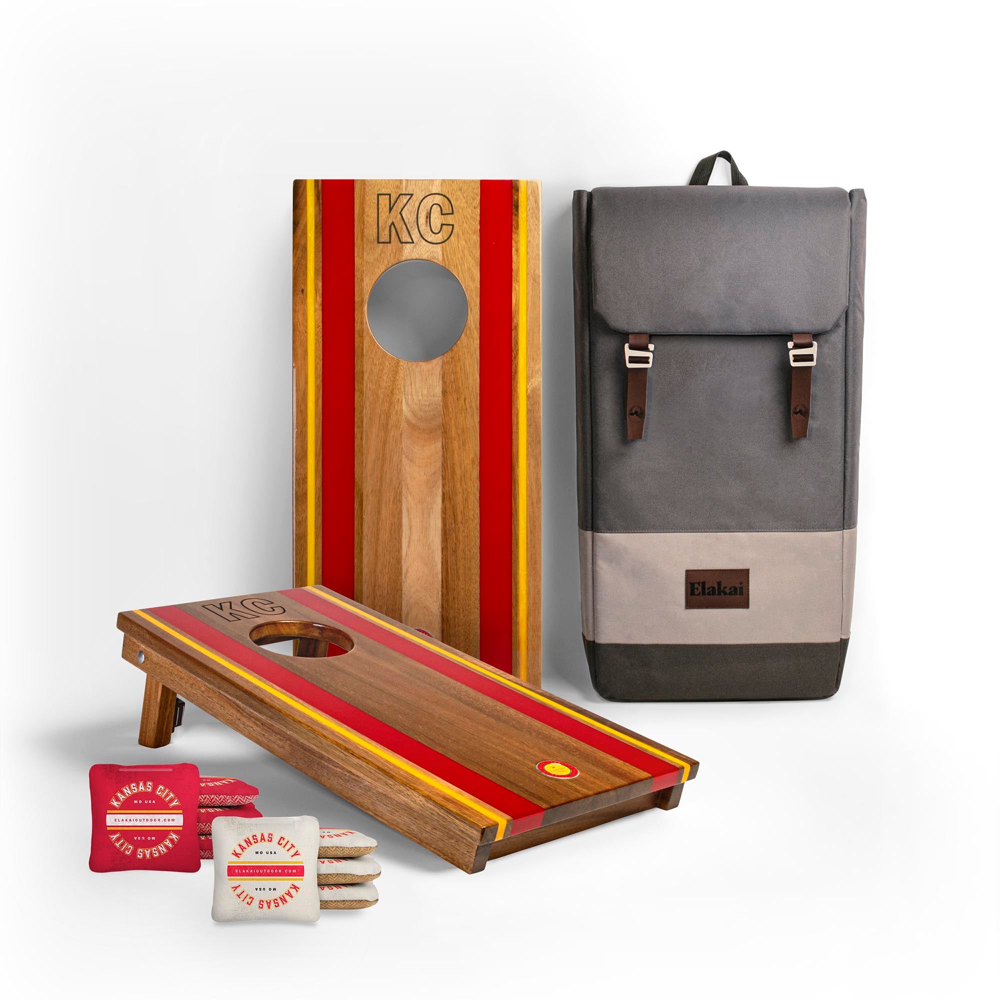 1x2 Gameday Resin Travel Cornhole Board Set with resin red and yellow stripes, a gray backpack and two sets of Kansas City cornhole bags
#color_kansas city