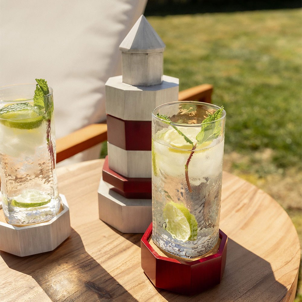 Lighthouse stacking coaster set styled with drinks on an outdoor table for coastal entertaining
