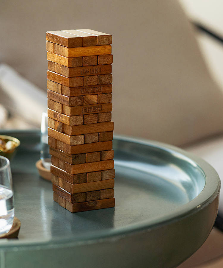 Mini Mountain Blocks wooden stacking game displayed on a modern side table in a contemporary living room.
