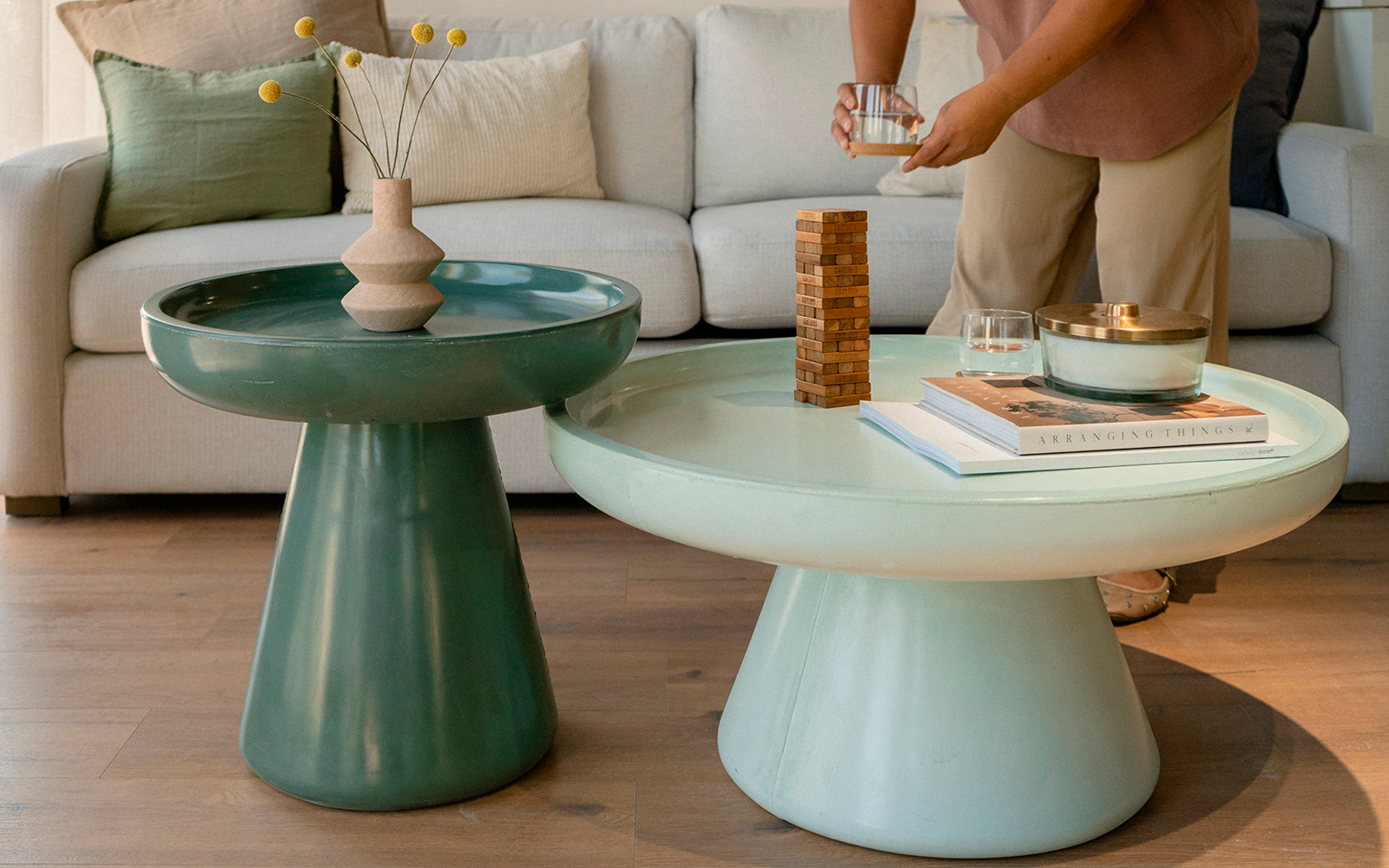 Mini Mountain Blocks wooden stacking game displayed on coffee tables in a modern living room as a person prepares to play.