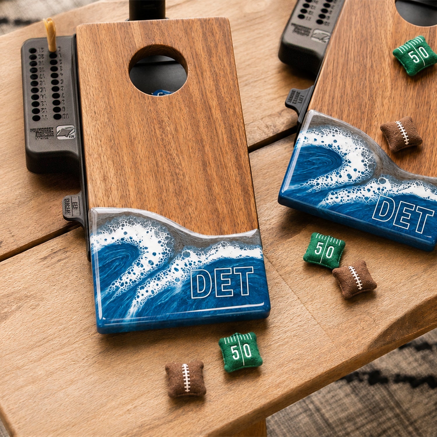 Two wooden cornhole boards featuring a blue, white, and gray wave design at the bottom with 'DET' lettering.

#color_detroit