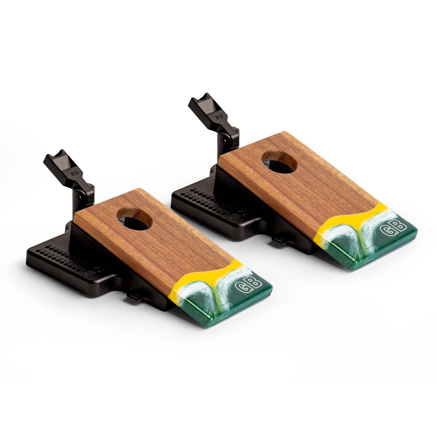 Angled view of the Elakai Green Bay Gameday mini double chuck tabletop cornhole set featuring wood boards with green, gold, and white resin design and built-in launch flippers #color_green bay