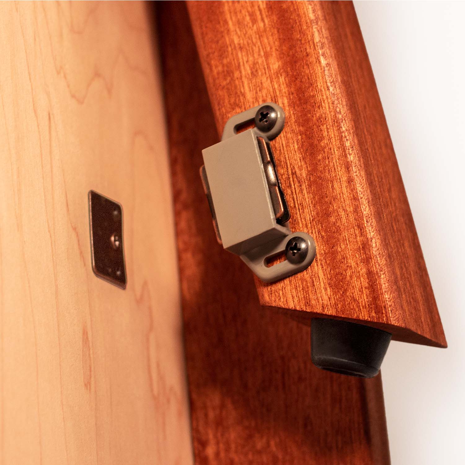 Close-up of folding leg hinge hardware on Elakai beach resin cornhole board
