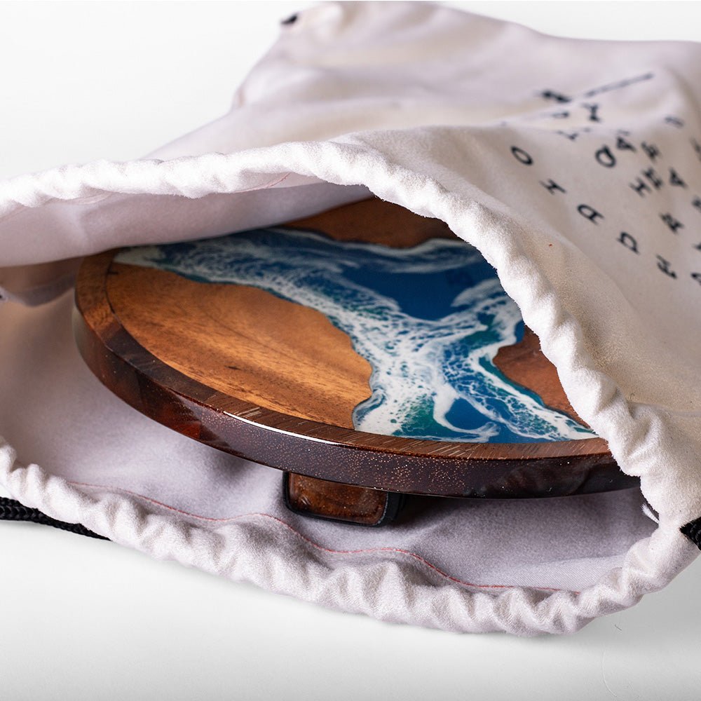 Elakai handcrafted resin paddle stored inside the included drawstring travel bag