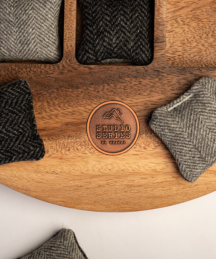Close-up of the Studio Series Tic Tac Toe game crafted from acacia wood with woven bean bags.